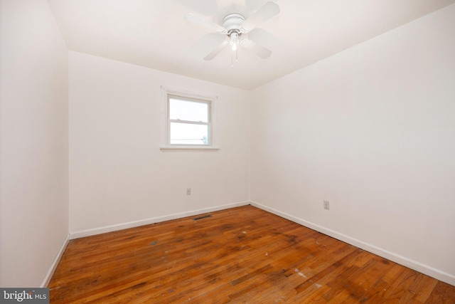 unfurnished room with ceiling fan and hardwood / wood-style flooring