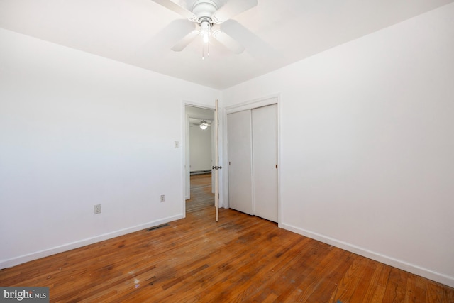 spare room with ceiling fan and wood-type flooring