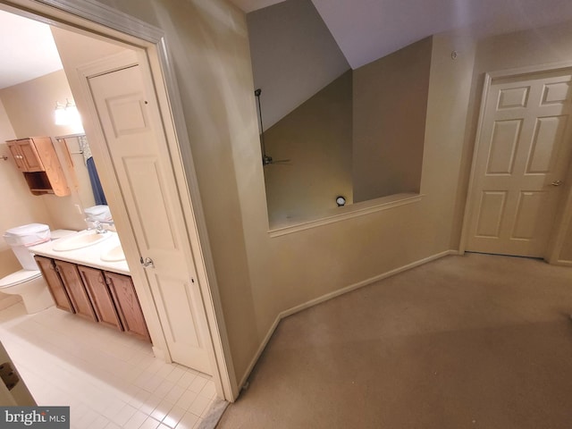 bathroom featuring vanity and vaulted ceiling