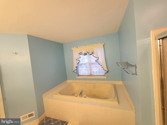 bathroom with tiled tub