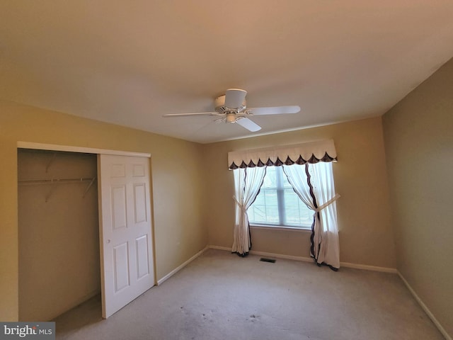 unfurnished bedroom with visible vents, baseboards, a ceiling fan, light colored carpet, and a closet