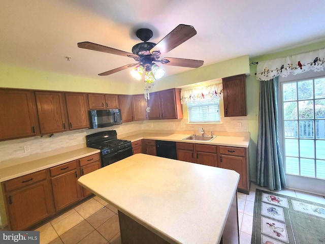 kitchen with light tile patterned floors, a sink, light countertops, black appliances, and backsplash