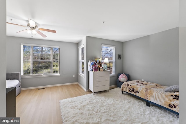 bedroom with ceiling fan and light wood-type flooring