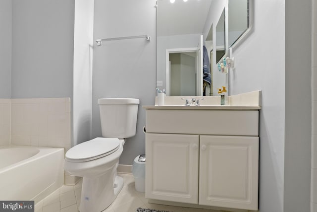 bathroom featuring tile patterned floors, vanity, toilet, and a bath