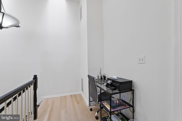 home office with light hardwood / wood-style floors