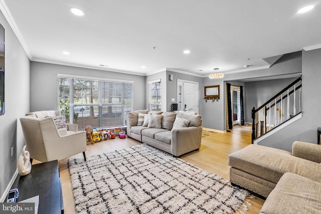 living room with ornamental molding and light wood-type flooring