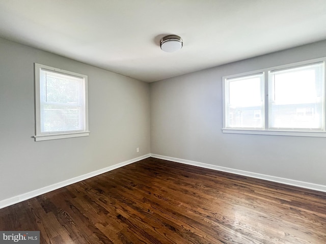 unfurnished room featuring dark wood-type flooring