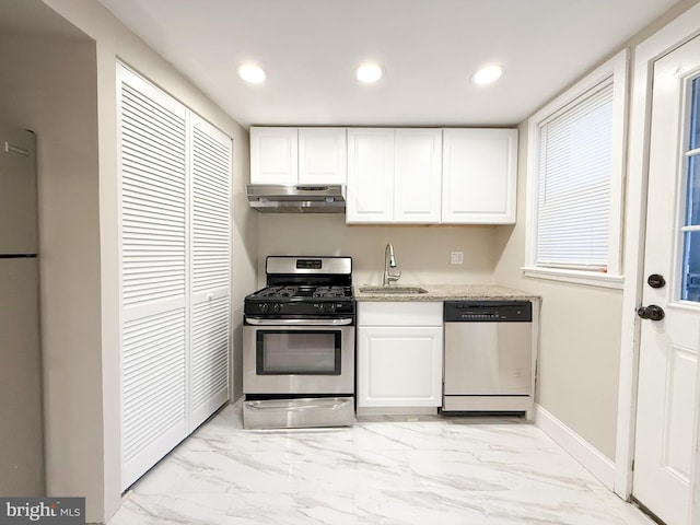 kitchen with stainless steel range with gas cooktop, sink, white refrigerator, dishwasher, and white cabinetry