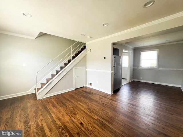 unfurnished living room featuring crown molding and dark wood-type flooring