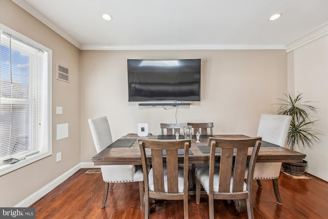 dining space with visible vents, baseboards, dark wood-type flooring, and crown molding