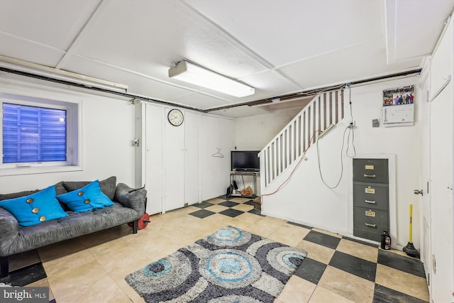 finished basement featuring stairway and tile patterned floors