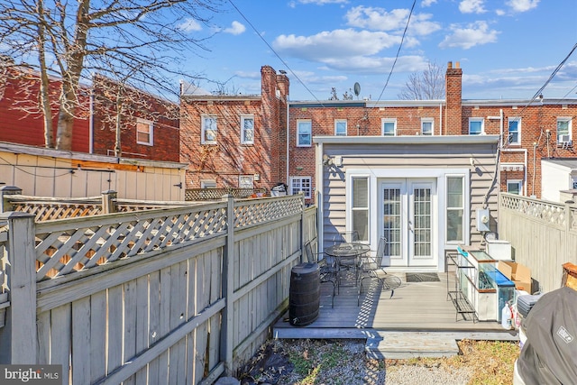 back of property featuring a fenced backyard and a deck