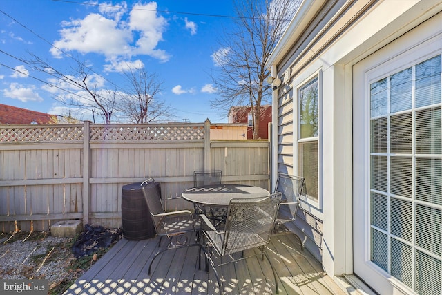 wooden terrace with fence and outdoor dining space