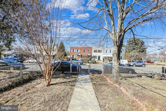 exterior space featuring a residential view and fence