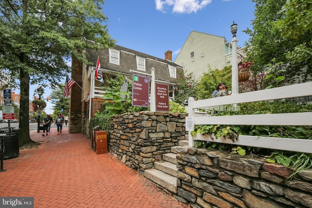 view of front of home featuring central air condition unit and brick siding