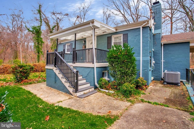 view of front of home featuring cooling unit and covered porch