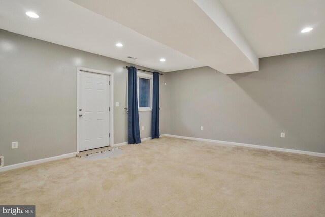 basement featuring light colored carpet