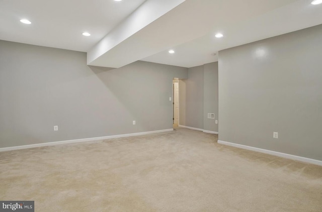 basement featuring light colored carpet