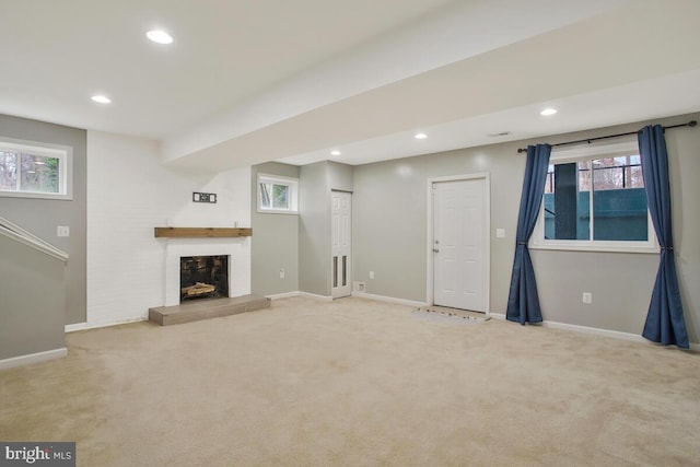 unfurnished living room with carpet floors and a healthy amount of sunlight