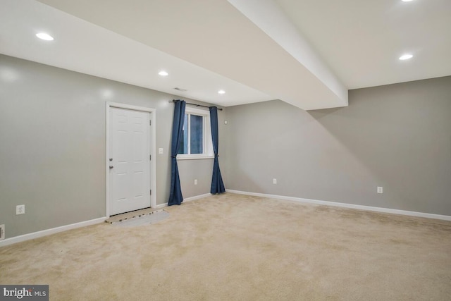 basement featuring light carpet