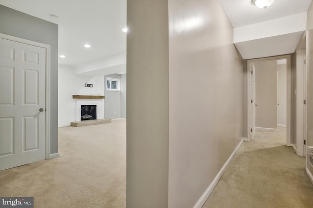 hall featuring light colored carpet