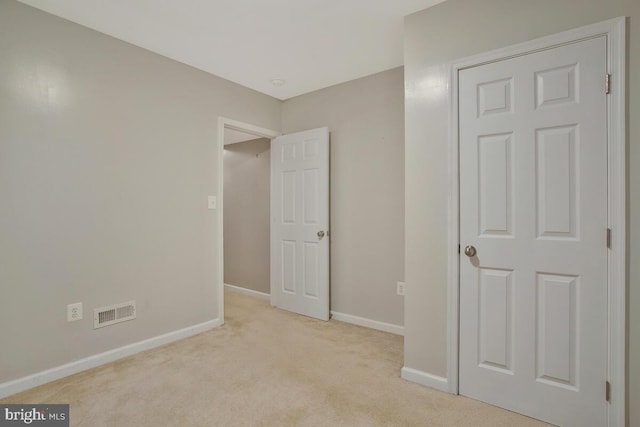 unfurnished bedroom featuring light colored carpet