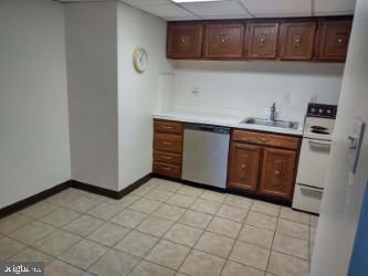 kitchen with dishwasher, a drop ceiling, white electric range, and sink