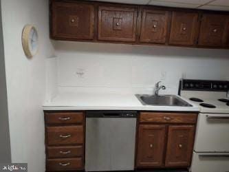 kitchen featuring stainless steel dishwasher, sink, dark brown cabinetry, and white electric stove