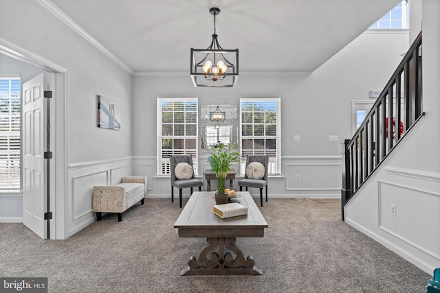 living area with a chandelier, carpet flooring, and a wealth of natural light