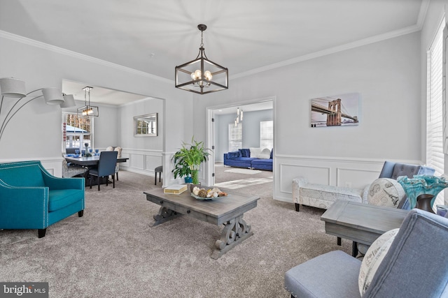 carpeted living room with a chandelier and ornamental molding