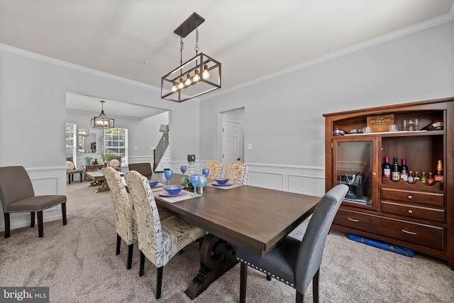 carpeted dining space featuring ornamental molding