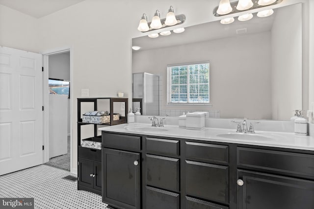 bathroom with a chandelier, vanity, and walk in shower