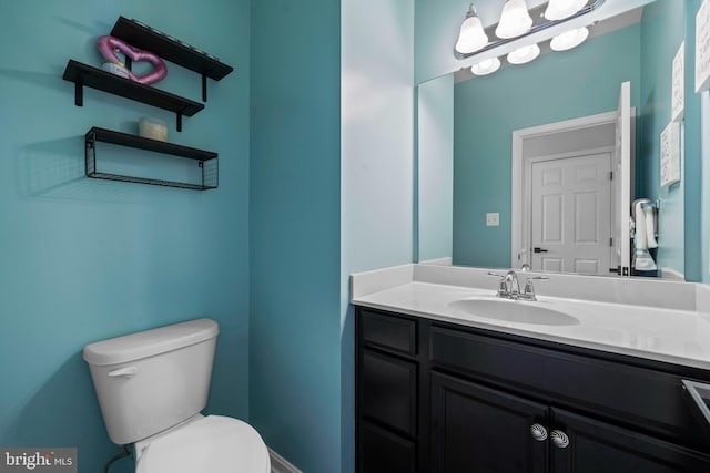 bathroom featuring vanity and toilet