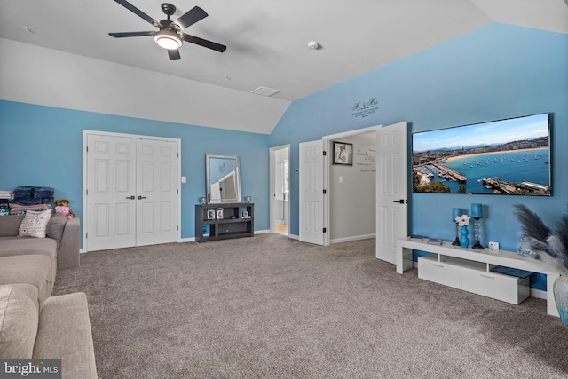 living room with carpet flooring, ceiling fan, and lofted ceiling