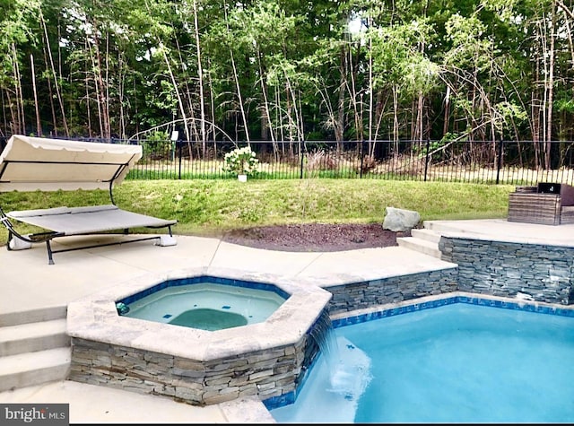 view of swimming pool featuring an in ground hot tub