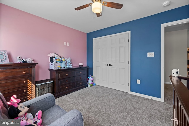 carpeted bedroom with ceiling fan and a closet