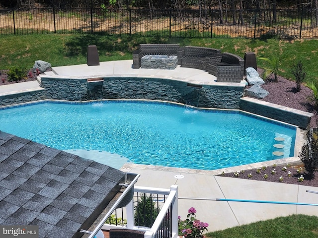 view of pool featuring pool water feature and a patio