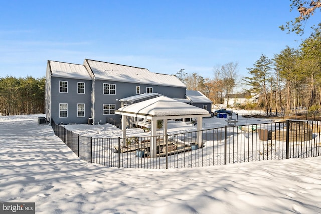 snow covered house with central AC