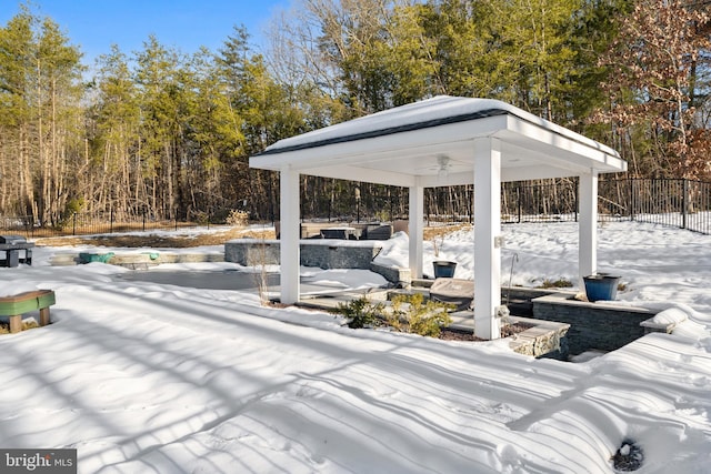 snow covered patio featuring a gazebo and ceiling fan