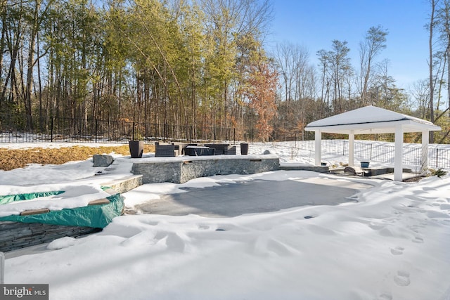 yard layered in snow with a gazebo