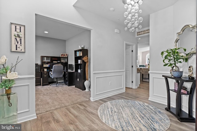 office area with a chandelier and light hardwood / wood-style flooring