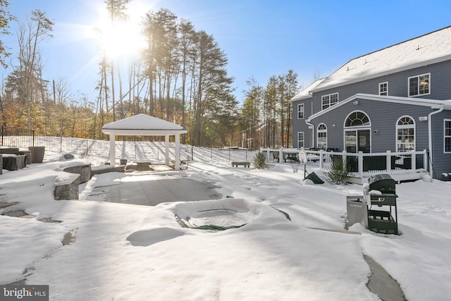 yard covered in snow with a gazebo