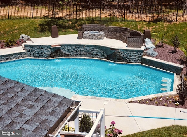 view of pool featuring pool water feature and a patio area