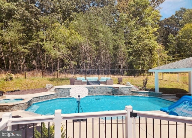 view of swimming pool with a jacuzzi and an outdoor hangout area