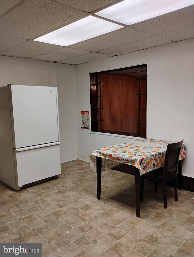 dining room with a drop ceiling