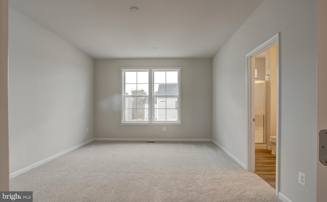 empty room with light colored carpet