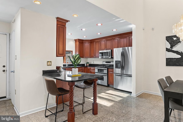 kitchen with kitchen peninsula, sink, and appliances with stainless steel finishes