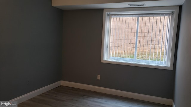 unfurnished room with wood-type flooring