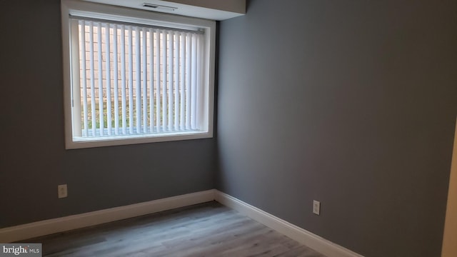 empty room with hardwood / wood-style flooring