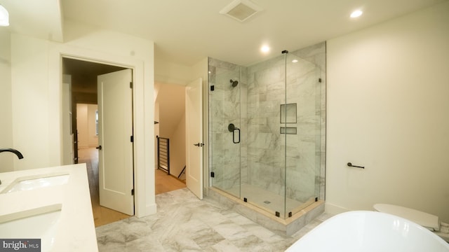 bathroom with vanity and independent shower and bath